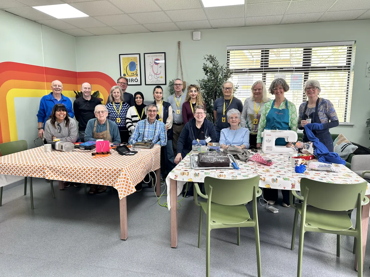 The repair café and BridgeLink centre team with people using the repair cafe services all sat or stood in the dedicated room for the service